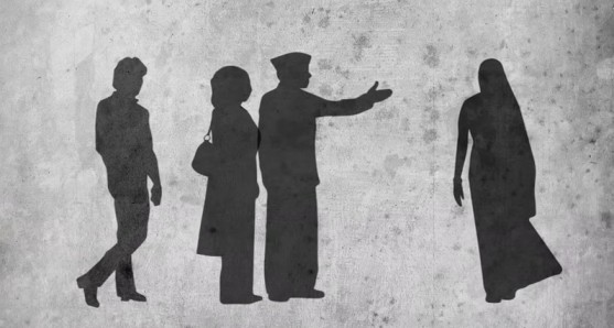 A woman turning away from a man and his family